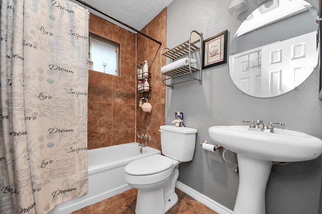 bathroom with toilet, tile patterned flooring, shower / tub combo, and a textured ceiling