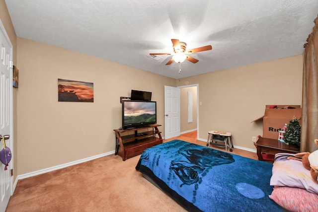 carpeted bedroom featuring a textured ceiling and ceiling fan