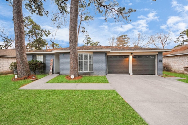 ranch-style home with a garage and a front lawn