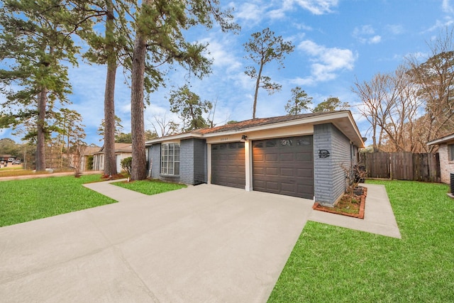 ranch-style house featuring a garage and a front yard