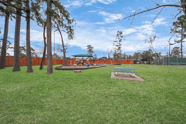 view of property's community featuring a playground and a yard