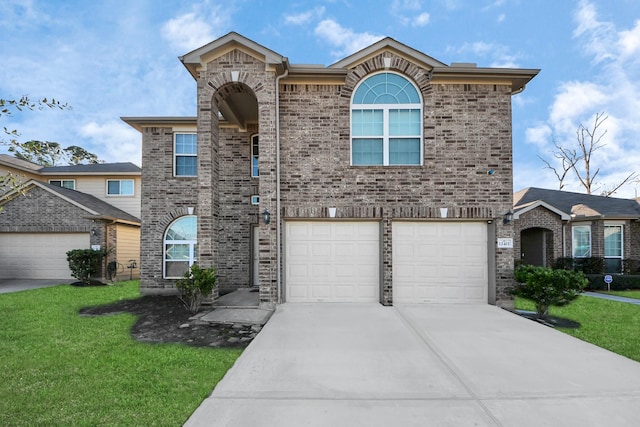 view of front property with a garage and a front lawn