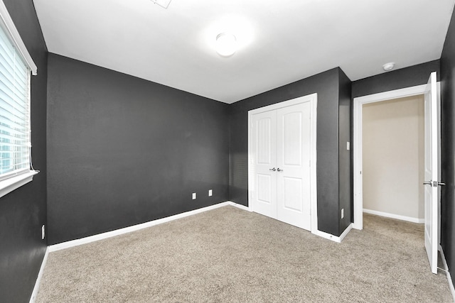 unfurnished bedroom featuring a closet and carpet