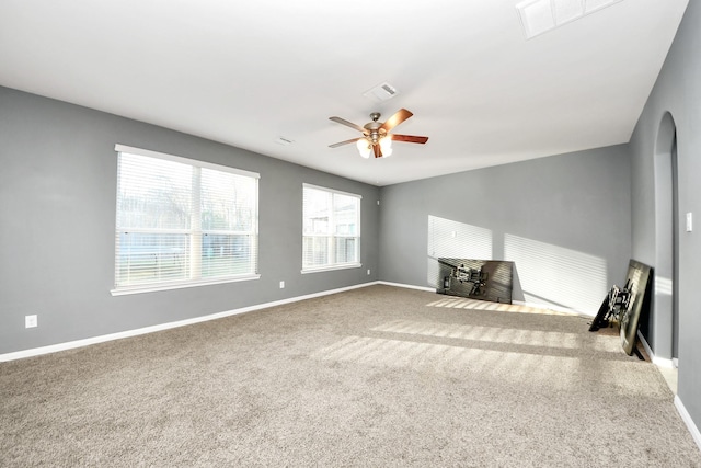 unfurnished living room with ceiling fan and carpet flooring