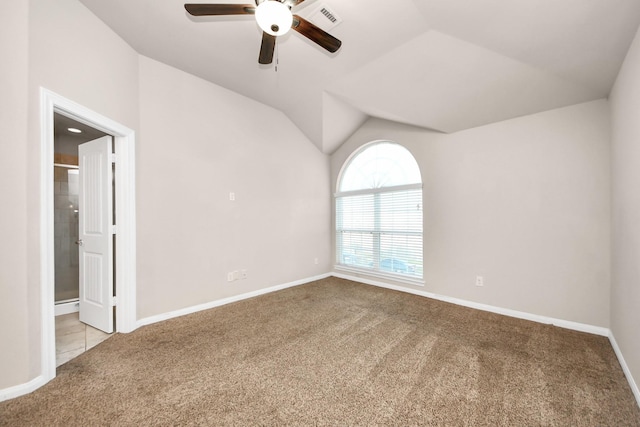 spare room featuring lofted ceiling, light colored carpet, and ceiling fan