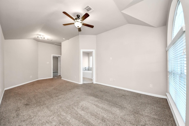 spare room featuring vaulted ceiling, carpet, and ceiling fan