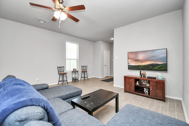 living room with ceiling fan and light hardwood / wood-style floors