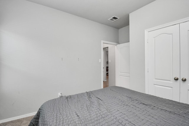 carpeted bedroom with a closet