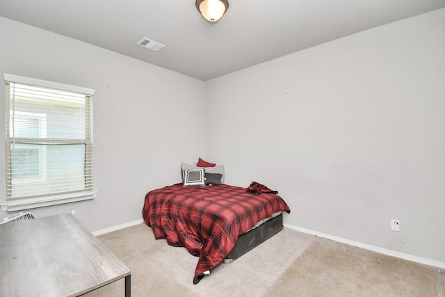 bedroom featuring light colored carpet