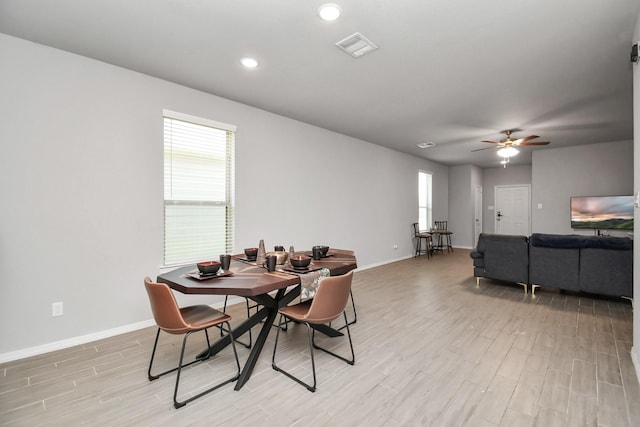 dining space featuring ceiling fan and light wood-type flooring