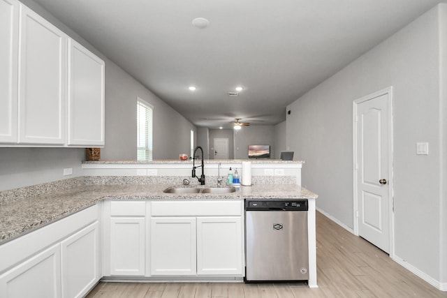 kitchen with white cabinetry, dishwasher, and sink