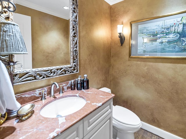 bathroom featuring crown molding, vanity, and toilet