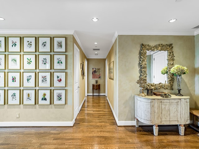 hallway with hardwood / wood-style flooring and crown molding