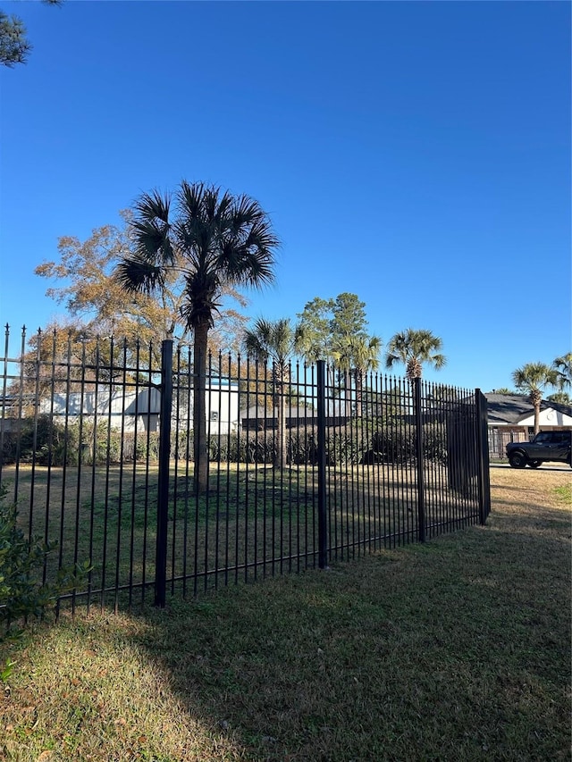 view of gate featuring a lawn