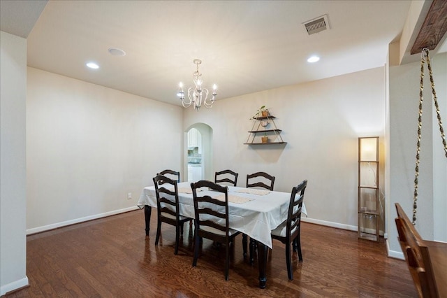 dining space featuring an inviting chandelier and dark hardwood / wood-style flooring