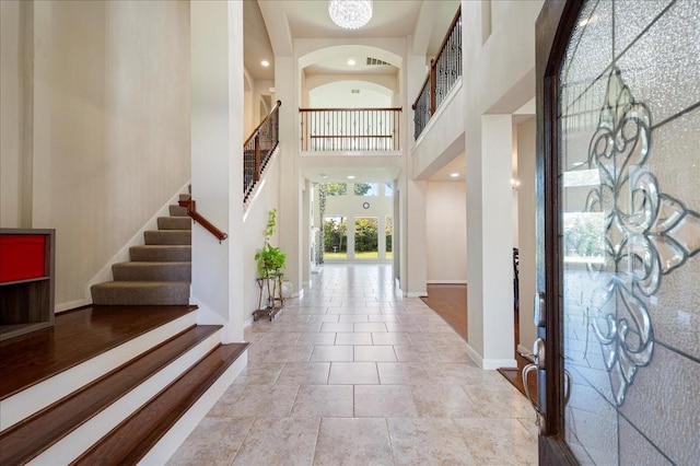 foyer featuring a chandelier and a high ceiling