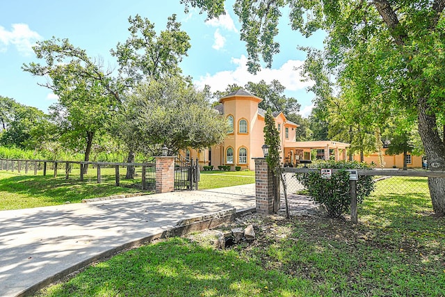 surrounding community featuring a gate, a yard, and a fenced front yard