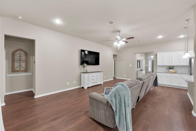 living room with ceiling fan and dark hardwood / wood-style flooring