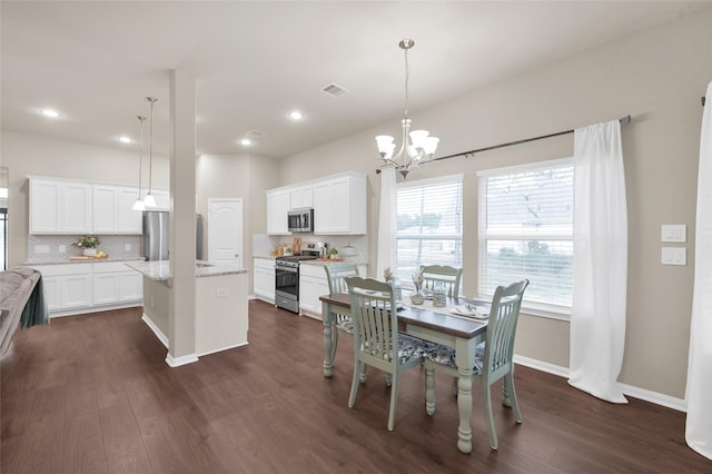 dining area with an inviting chandelier and dark wood-type flooring