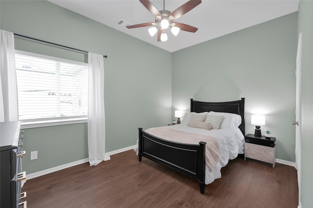 bedroom with ceiling fan and dark hardwood / wood-style flooring