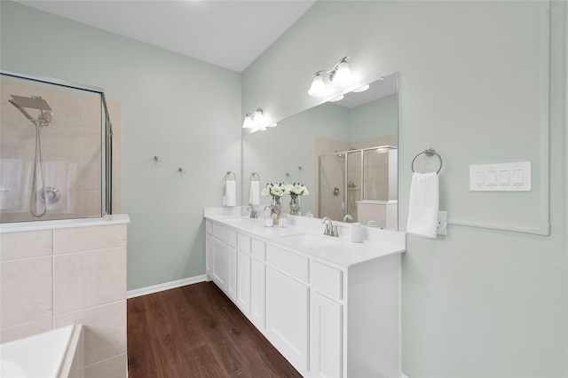 bathroom featuring vanity, wood-type flooring, and a shower with door