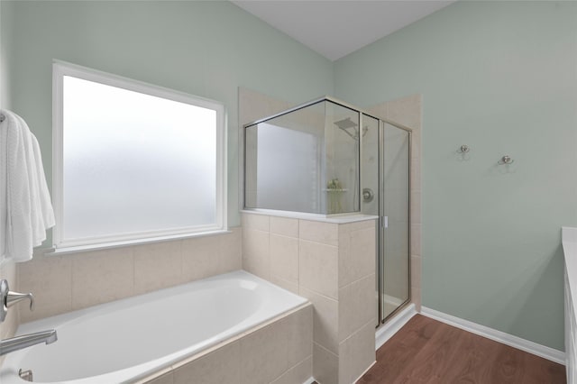 bathroom featuring shower with separate bathtub and hardwood / wood-style floors