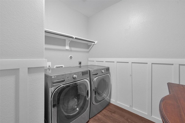 laundry area with dark wood-type flooring and washing machine and dryer