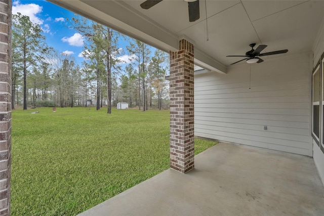 view of yard featuring a patio area and ceiling fan