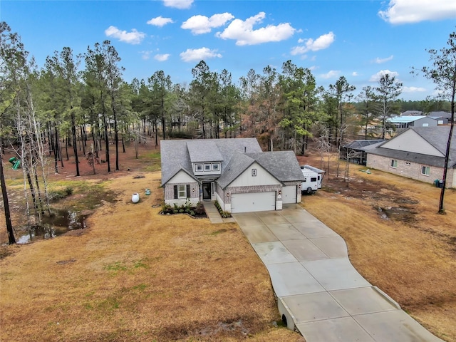 view of front of property featuring a garage and a front yard