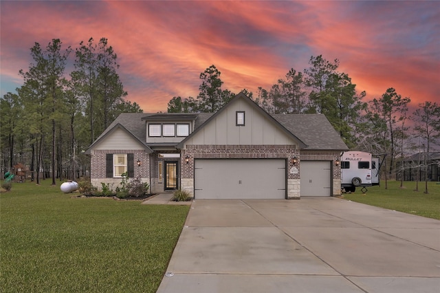 view of front of property featuring a yard and a garage