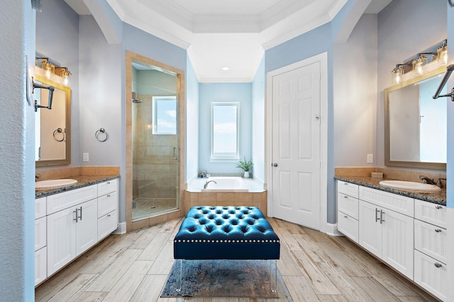 bathroom with ornamental molding, shower with separate bathtub, and vanity