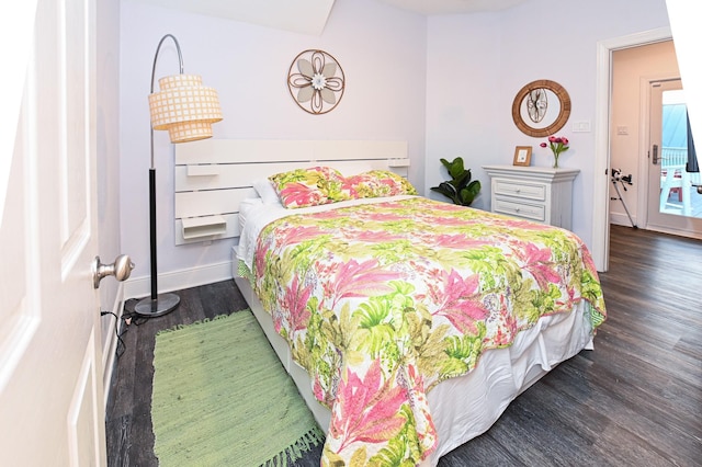 bedroom with dark hardwood / wood-style flooring