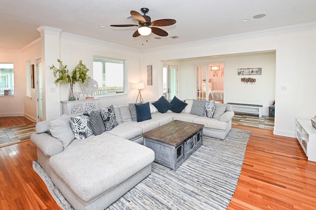 living room featuring crown molding, hardwood / wood-style flooring, and ceiling fan