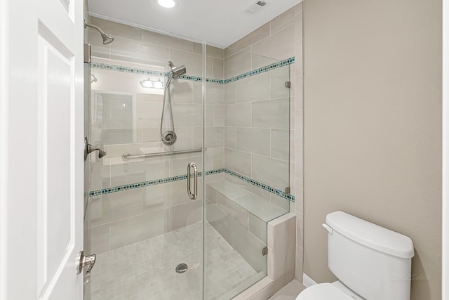 bathroom with walk in shower and toilet