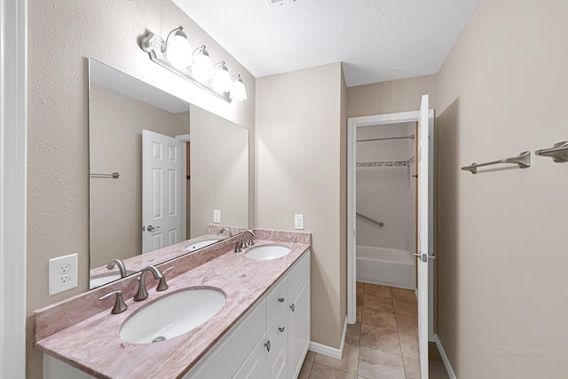 bathroom featuring vanity, tile patterned floors, and a textured ceiling