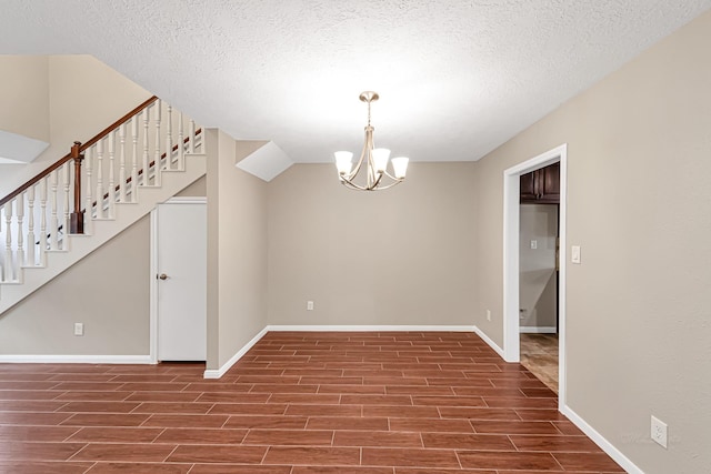 interior space with an inviting chandelier and a textured ceiling