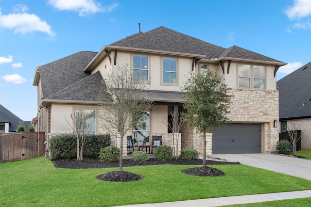 view of front facade with a garage, a porch, and a front lawn