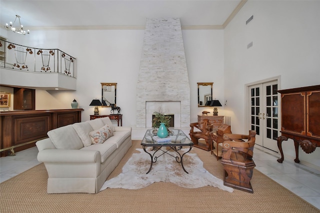 living area featuring tile patterned flooring, a high ceiling, a fireplace, ornamental molding, and french doors