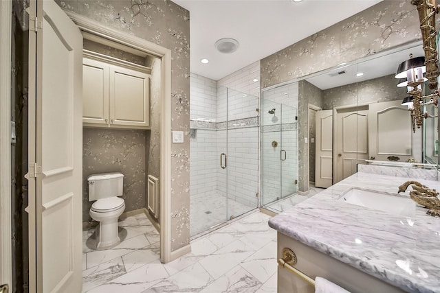 bathroom featuring toilet, visible vents, vanity, marble finish floor, and a shower stall