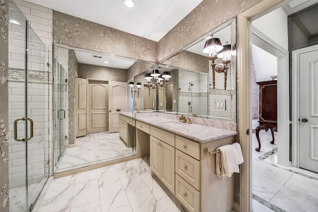 bathroom with marble finish floor, vanity, an inviting chandelier, and a stall shower