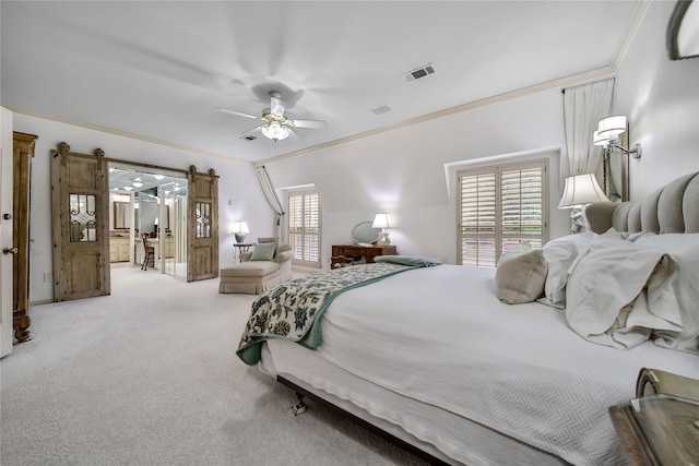 bedroom featuring carpet floors, crown molding, visible vents, a barn door, and a ceiling fan