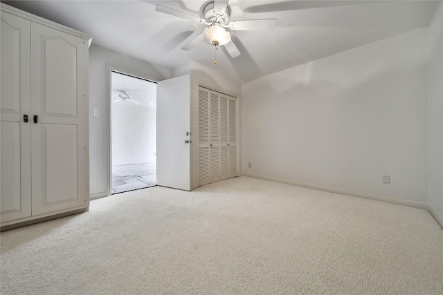 unfurnished bedroom featuring carpet floors, baseboards, and a ceiling fan