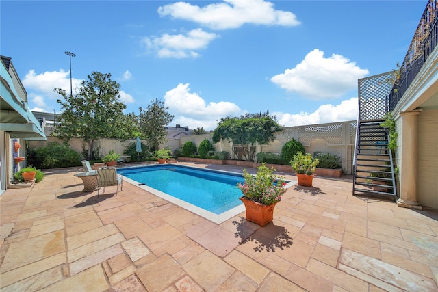 view of pool with stairs, a patio area, a fenced backyard, and a fenced in pool