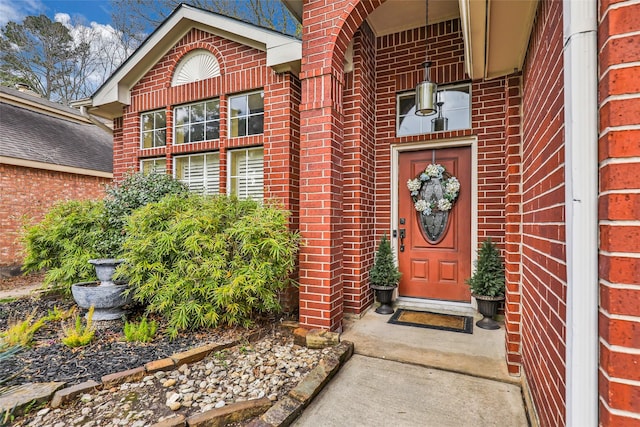 property entrance featuring brick siding