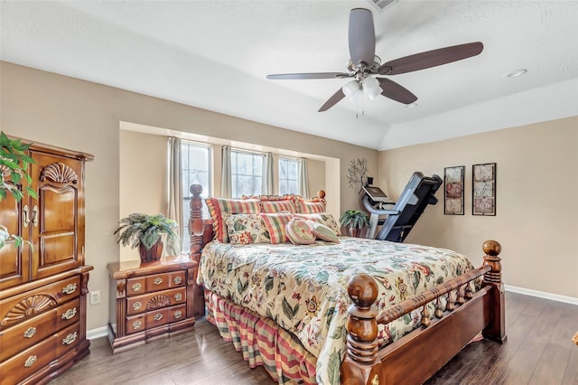 bedroom featuring a ceiling fan, baseboards, and wood finished floors