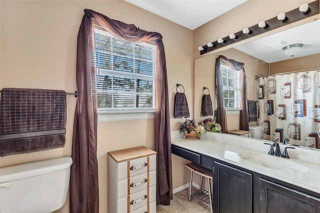 full bath with a shower with shower curtain, toilet, vanity, and tile patterned flooring