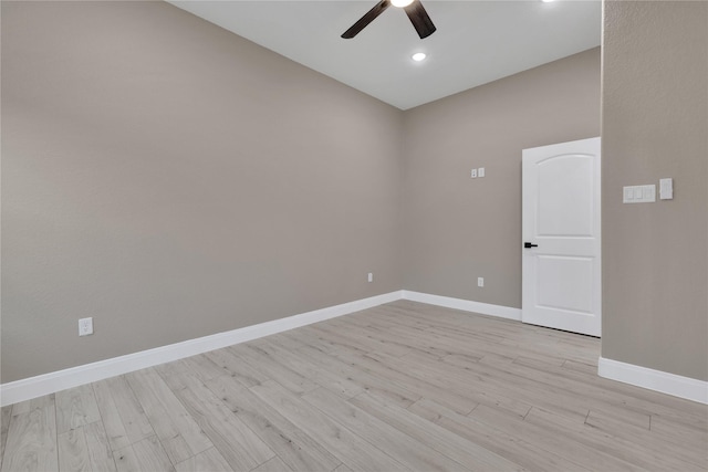 empty room with ceiling fan and light hardwood / wood-style floors