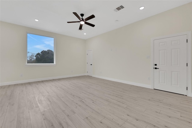 empty room with ceiling fan and light hardwood / wood-style floors