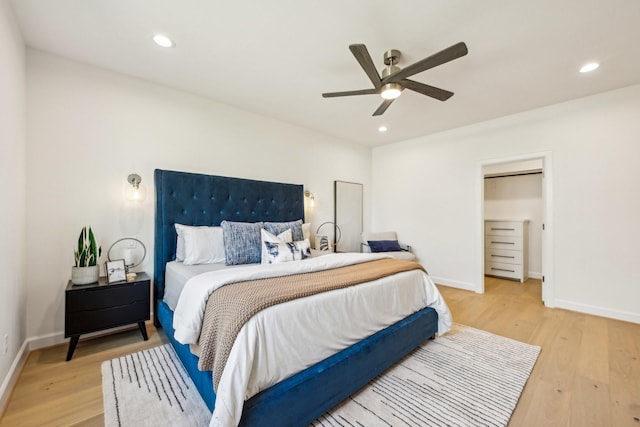 bedroom with ceiling fan and light wood-type flooring