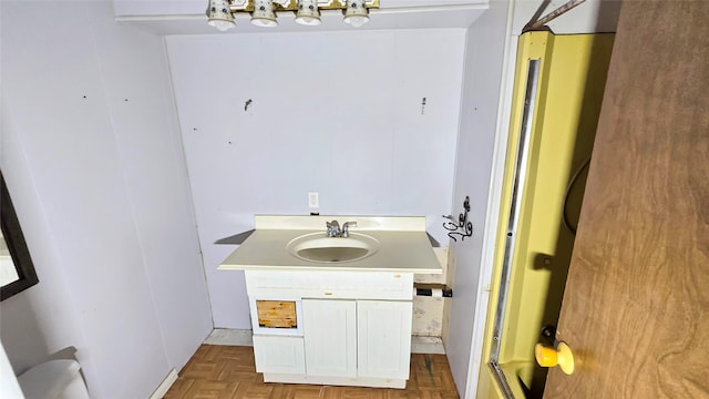 bathroom featuring parquet flooring and sink